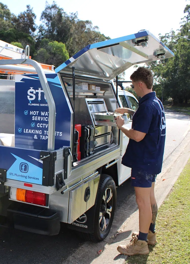 STL Plumbing's expert team unloading equipment from a ute providing Emergency Plumbing on the Gold Coast