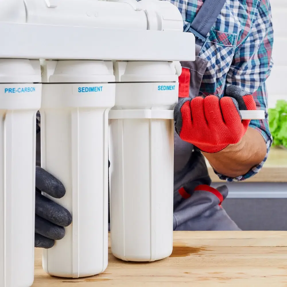 A Professional Plumber performing a home water filtration Installs on the Gold Coast